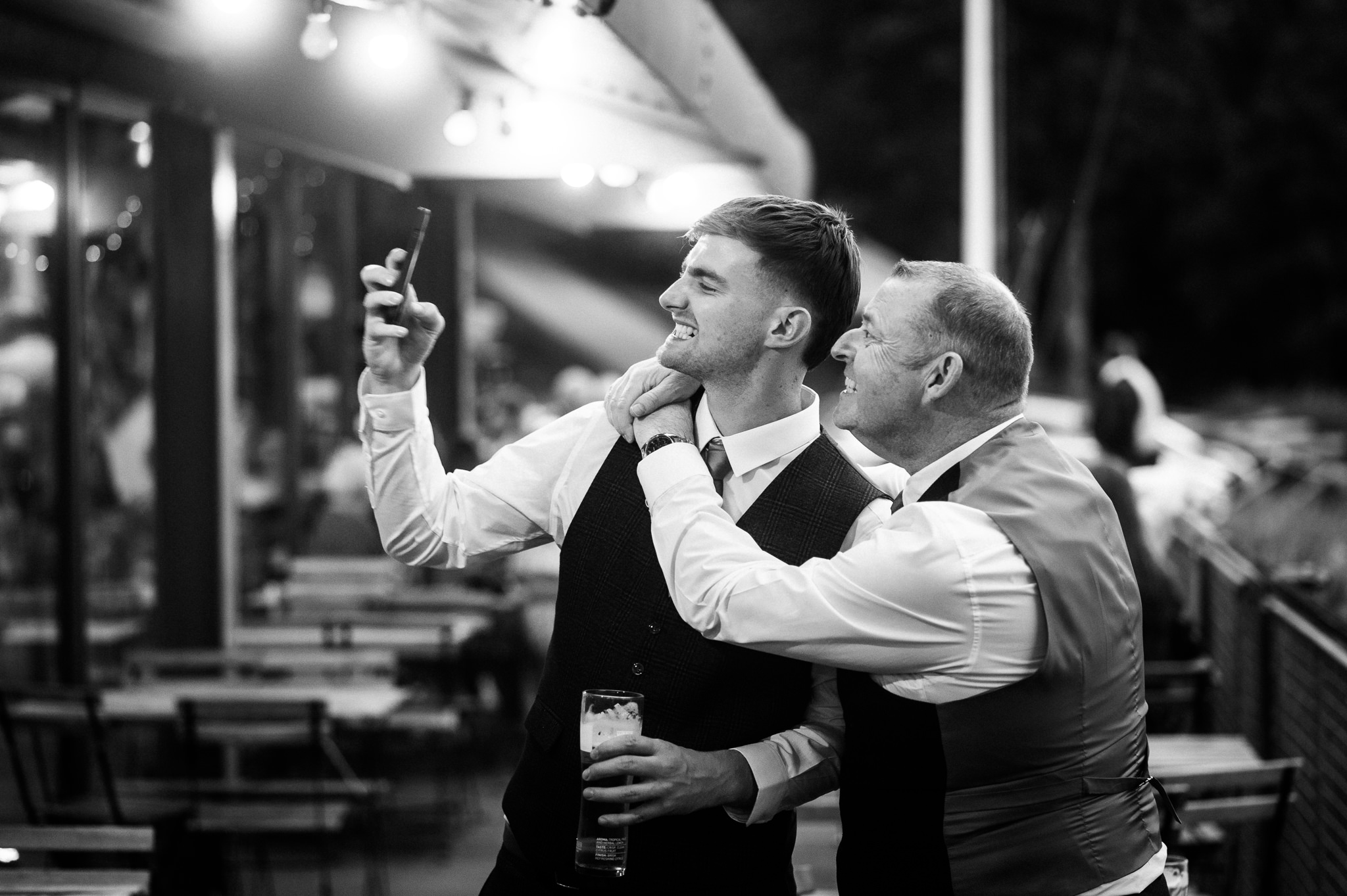 guests taking a cheesy grin selfie at a wedding