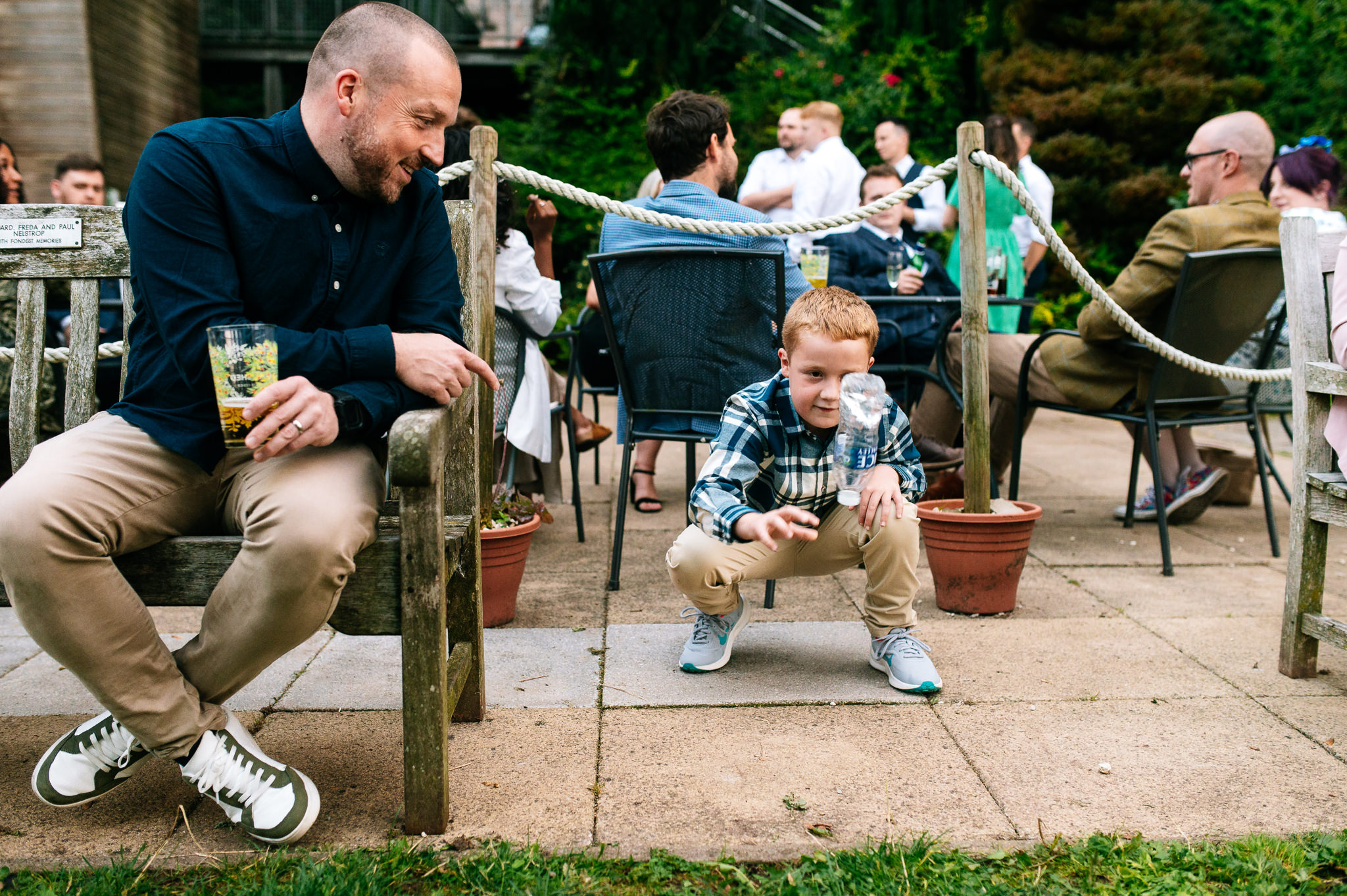a little boy and his dad playing the toss the bottle game