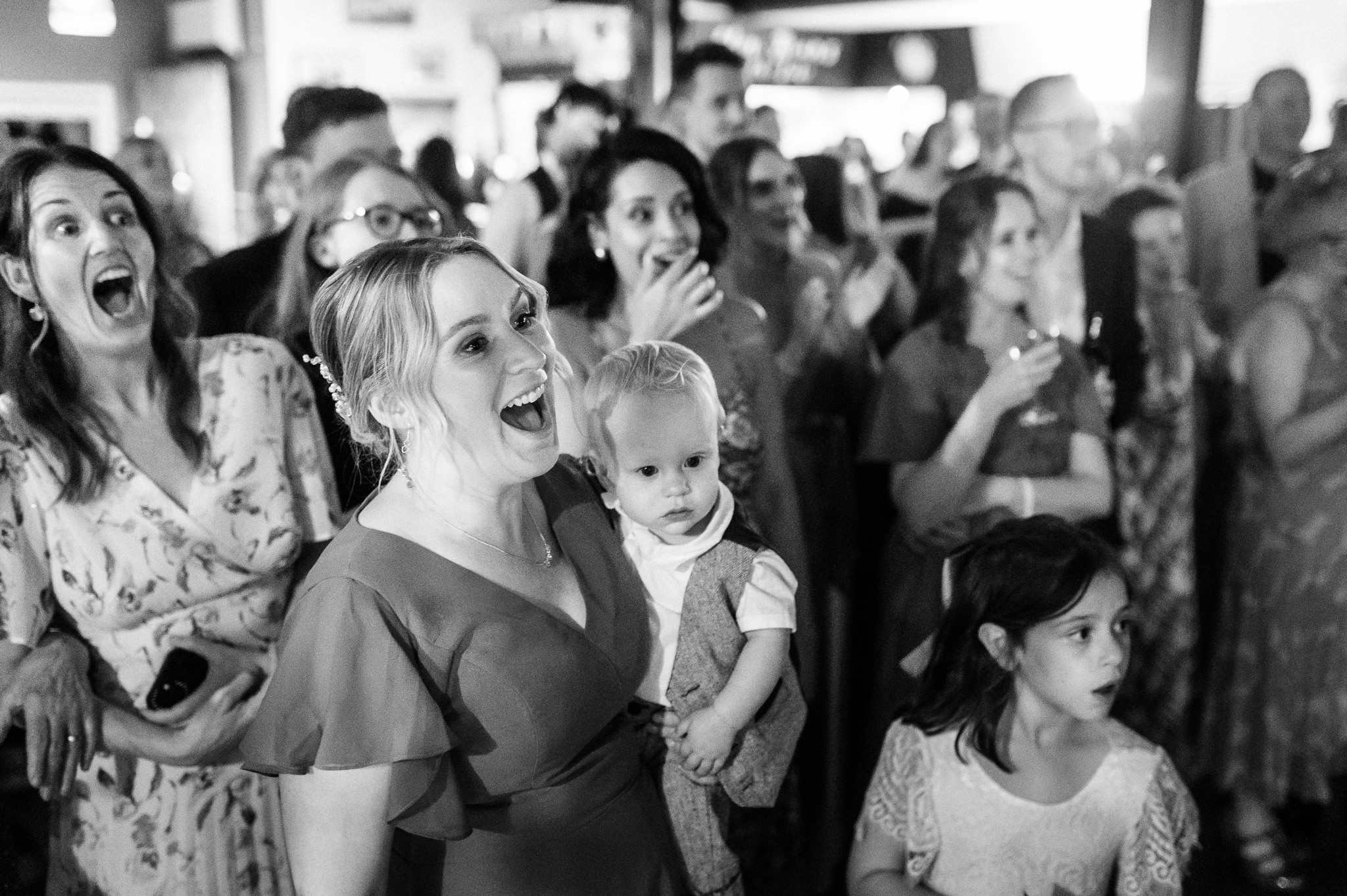 wedding guests react to something funny on the dance floor