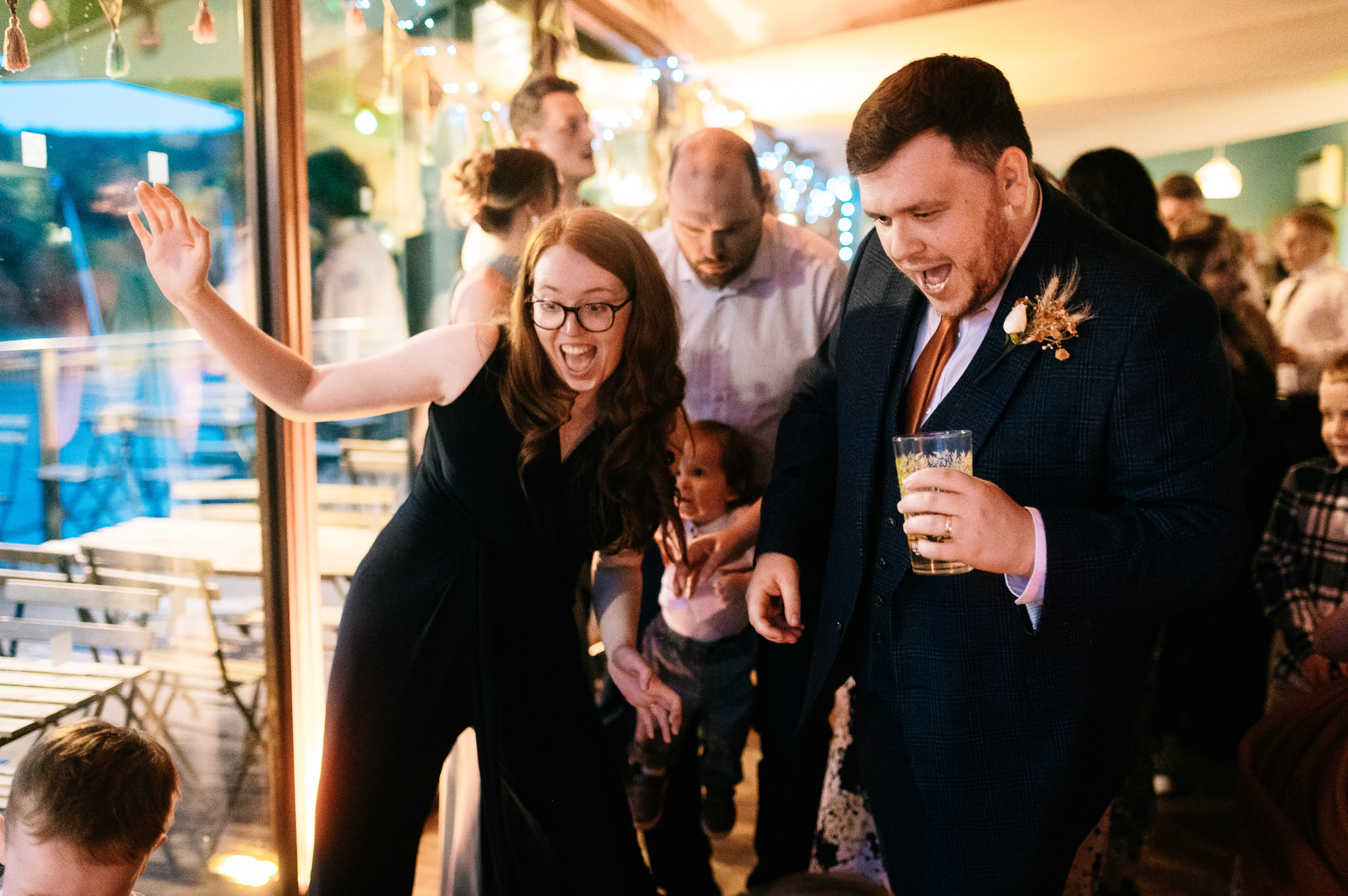 a man and a woman dancing and singing on the dance floor
