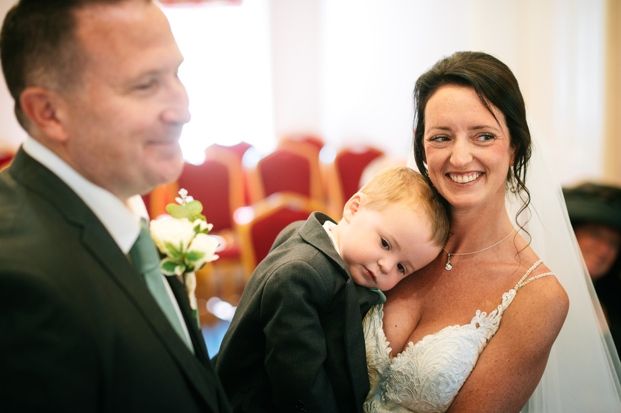 bride holding her young son during the wedding ceremony
