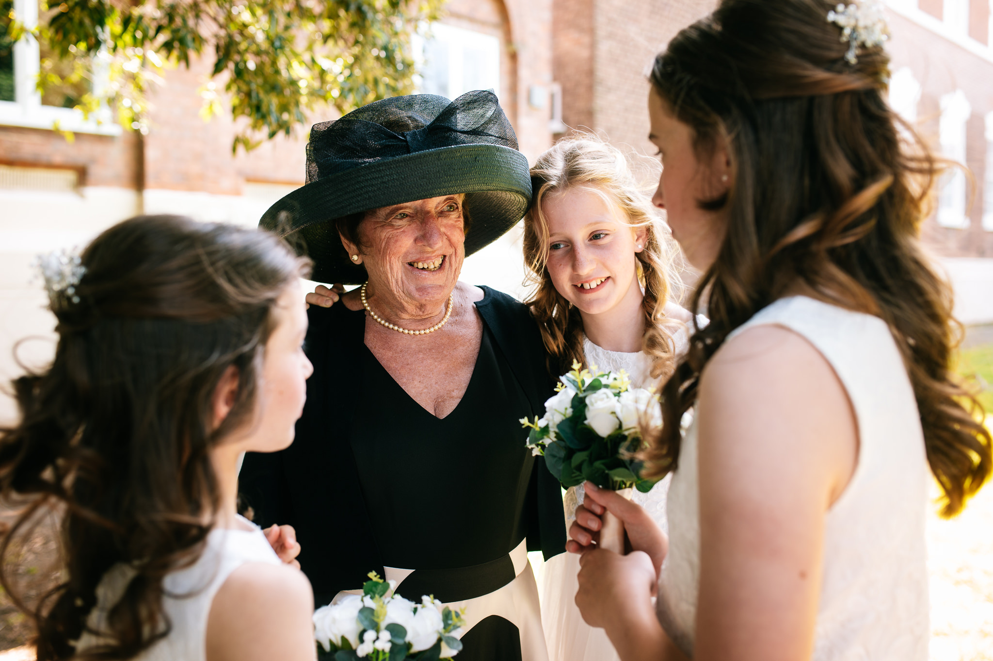 mother of the bride stood with her granddaughters around her