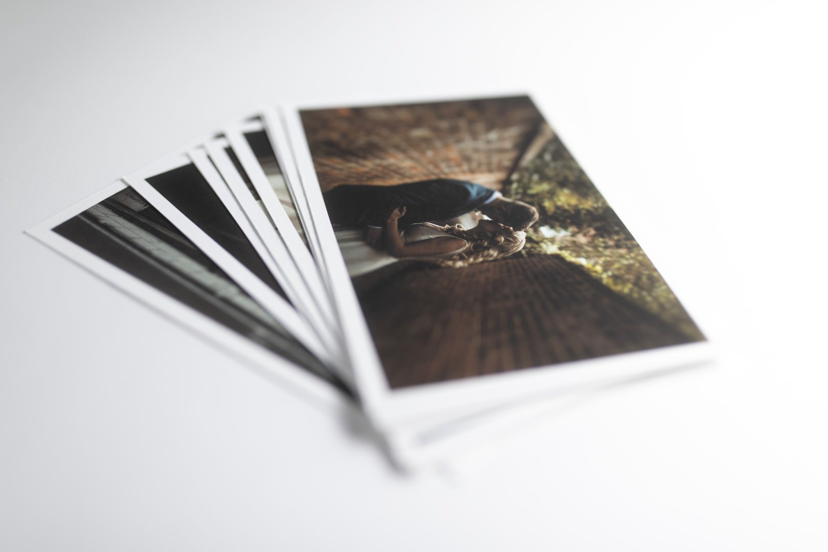 a selection of premium quality wedding photography prints fanned out on a white background